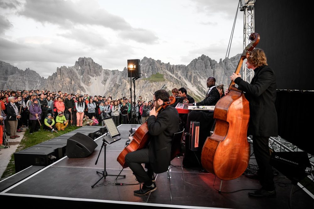 Freddie playing double bass on a festival stage